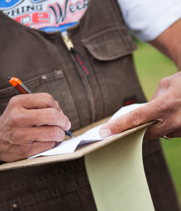 Guy writing on clipboard