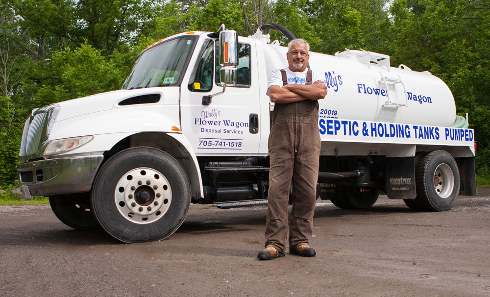 man standing in front of service vehicle